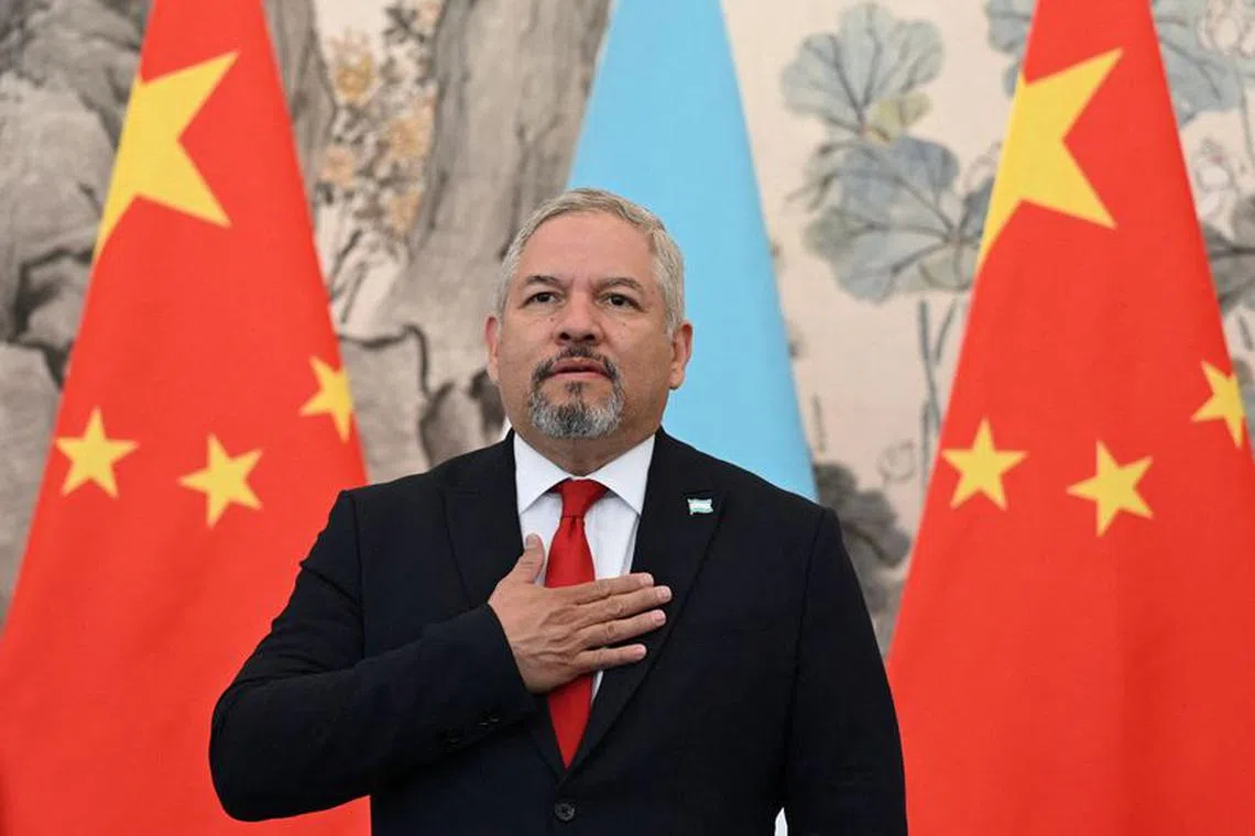Honduras Foreign Minister Eduardo Enrique Reina observes national anthems with his Chinese counterpart during a ceremony establishing diplomatic relations between the two countries, at the Diaoyutai State Guesthouse in Beijing, China March 26, 2023. Greg Baker/Pool via REUTERS/File Photo