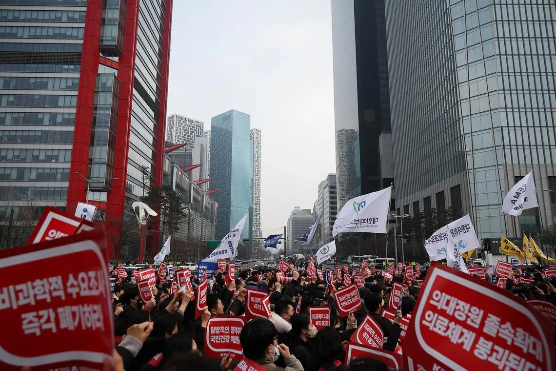 Doctors chant slogans during a rally to protest against government plans to increase medical school admissions in Seoul, South Korea, March 3, 2024.   REUTERS/Kim Hong-Ji