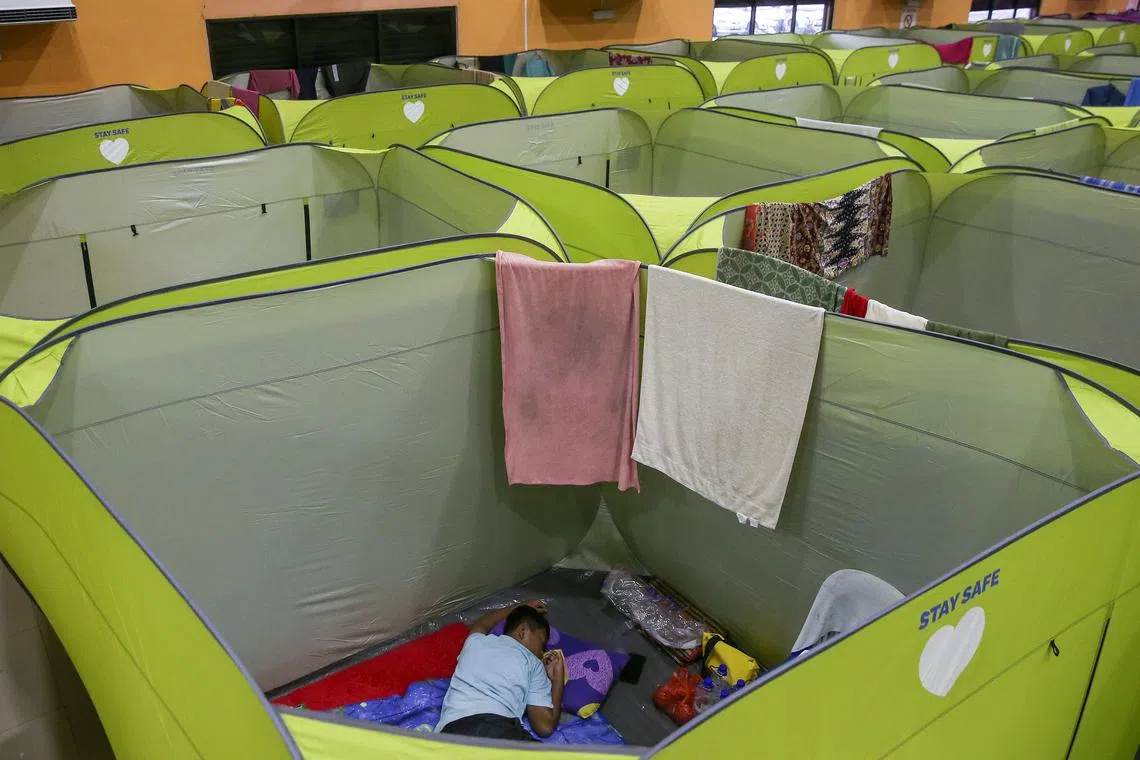 A man is sleeps inside a tent at an evacuation centre after some areas in Johor state were affected by flooding, Malaysia, March 5, 2023. 
