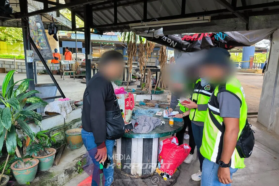 Malaysian immigration officials conducting inspection in Johor on Feb 25.