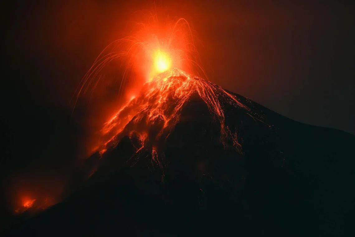Fuego volcano, as seen from Alotenango, a municipality in Sacatepequez department 65km southwest of Guatemala City, erupts on Dec 11, 2022. 