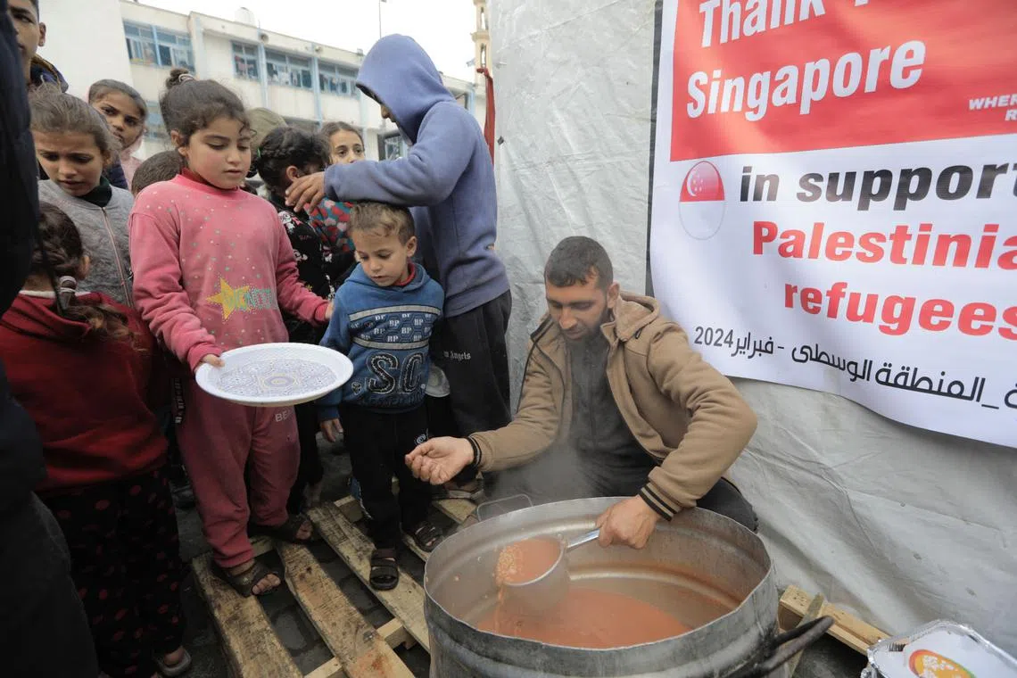 Children queueing up for hot soup at a kitchen run by International Relief Organisation. It has four such kitchens across Gaza, all funded by Love Aid Singapore.