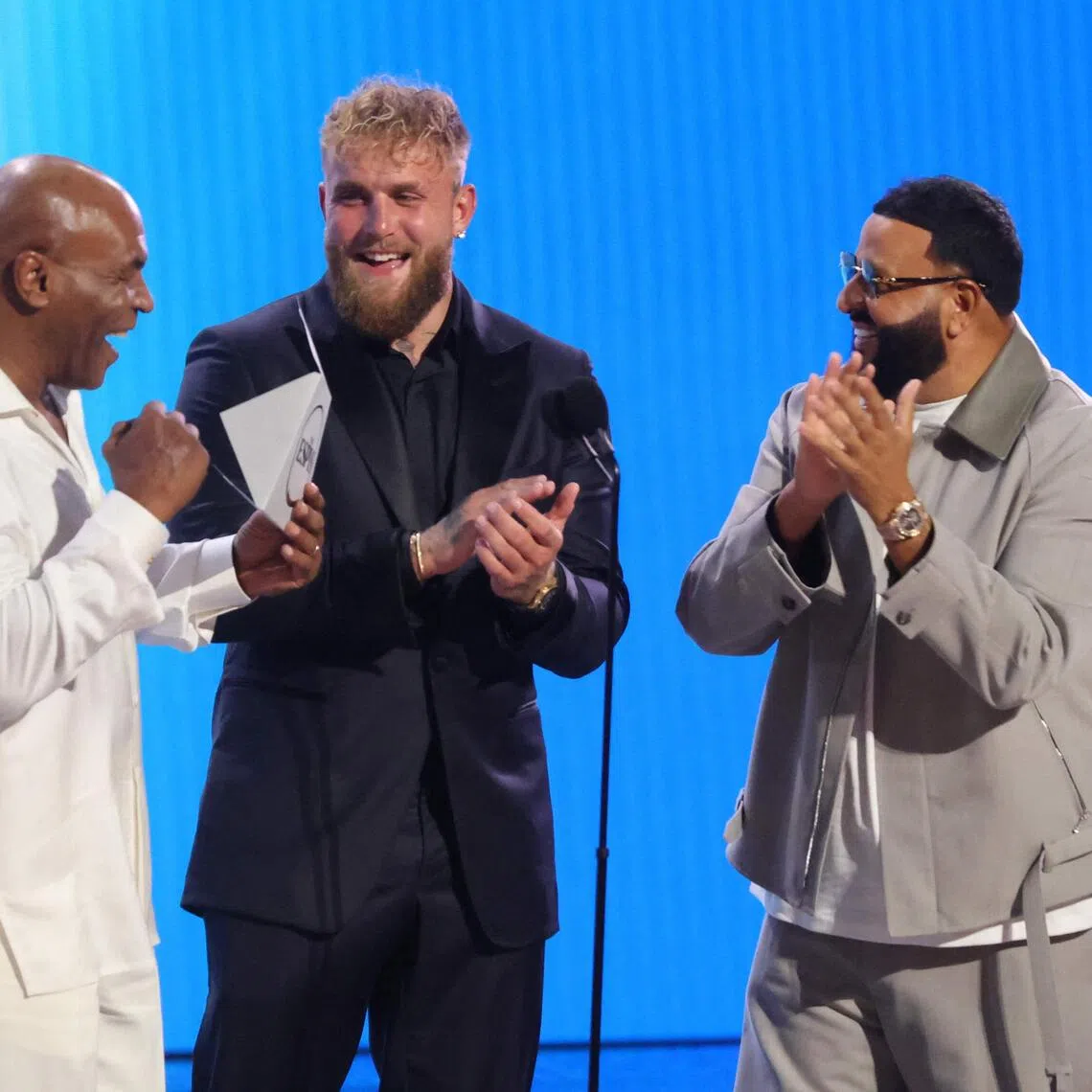 Jake Paul (centre) with legendary boxing champion Mike Tyson (left) and singer DJ Khaled at the ESPY Awards in July.