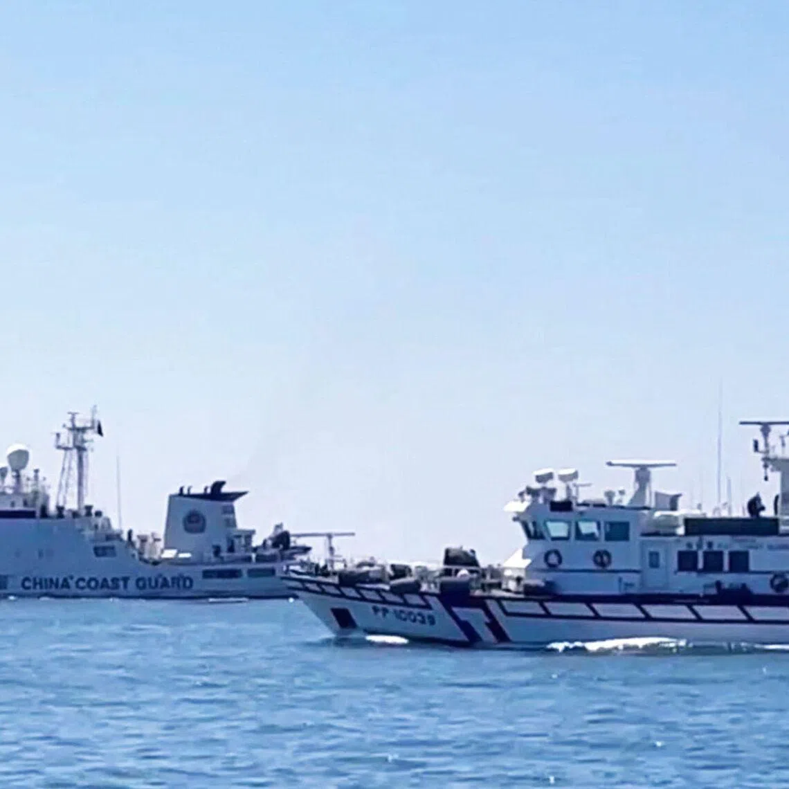 A Taiwan Coast Guard patrol vessel sailing near a China Coast Guard ship in the waters south of Kinmen, Taiwan.