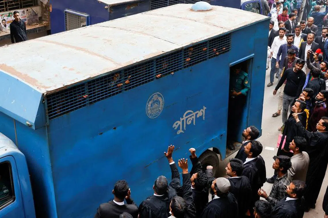Lawyers wave to the Bangladesh Nationalist Party activists in a prison van, who have been arrested during a countrywide mass arrest ahead of the General Election at the Chief Metropolitan Magistrate Court, in Dhaka, Bangladesh, December 18, 2023. REUTERS/Mohammad Ponir Hossain