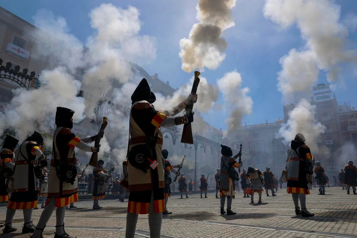 People in costumes taking part in Alardo Day during the Moors and Christians festivities in Alcoi, Spain, on April 27, 2026. Participants recreate the 1276 skirmishes between the two sides using muzzle-loading arquebuses.