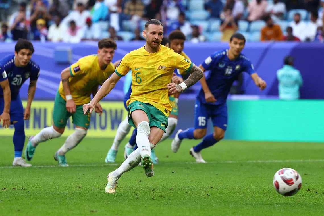 Australia's Martin Boyle scores from the penalty spot in the Asian Cup match against Uzbekistan.