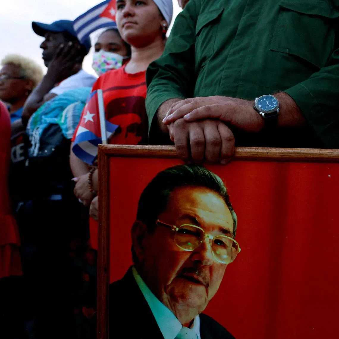 A person holding a picture of former Cuban president Raul Castro, as people gather on May 22 ahead of a pro-government rally against US policies towards the island, in Havana, Cuba.