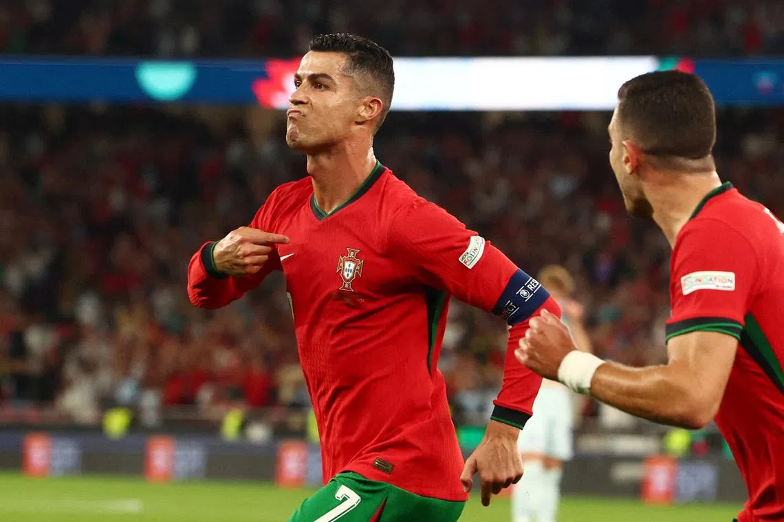 Soccer Football - Nations League - League A - Group 1 - Portugal v Scotland - Estadio da Luz, Lisbon, Portugal - September 8, 2024 Portugal's Cristiano Ronaldo celebrates scoring their second goal with Diogo Dalot REUTERS/Pedro Nunes     TPX IMAGES OF THE DAY