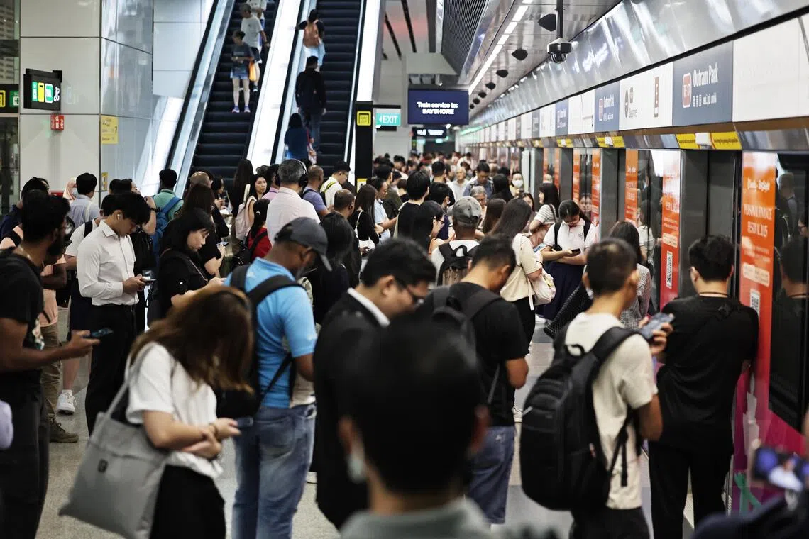 Members of the public still waiting on the platform area of Outram Park TEL MRT station on Sept 17, 2025. (ST Photo: Kelvin Chng)//At about 8.45 am staff alert TEL resume services at the Free shuttle services bus stop at the Outram Park TEL MRT station on Sept 17, 2025. (ST Photo Kelvin Chng)]