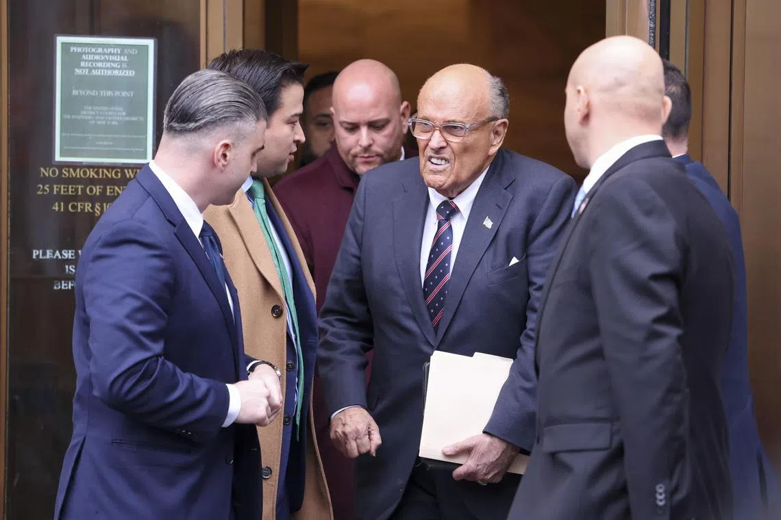 Rudy Giuliani (centre) leaving his court hearing in Georgia, on Nov 26.