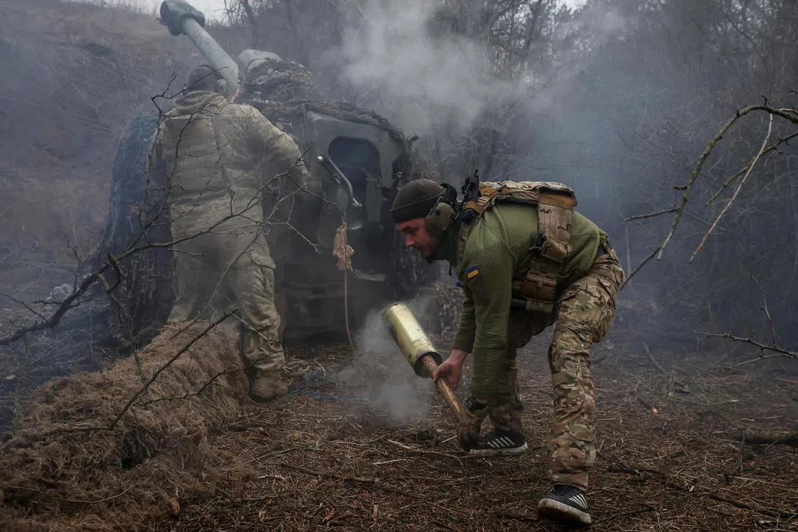 Ukrainian servicemen fire a D-30 howitzer towards Russian troops, in Ukraine's Kherson region.