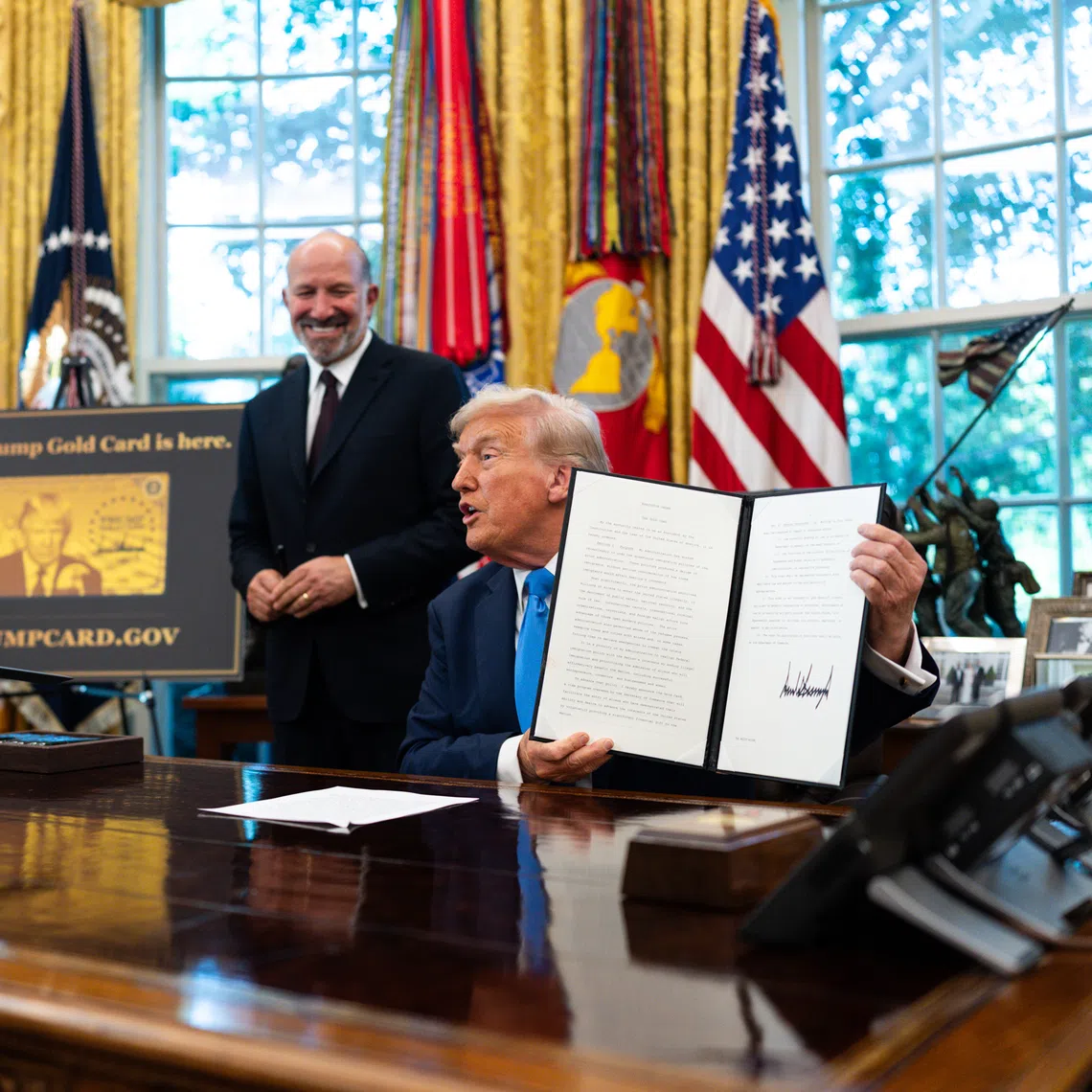 President Donald Trump after signing a proclamation instituting a $100,000 fee for visas given to some highly skilled foreign workers in the Oval Office on Friday, Sept. 19, 2025. The Trump administration sought to address the confusion on Saturday by saying that the fee would only apply to new applicants, and renewals or current visa holders would not be affected. (Tierney L. Cross/The New York Times)
