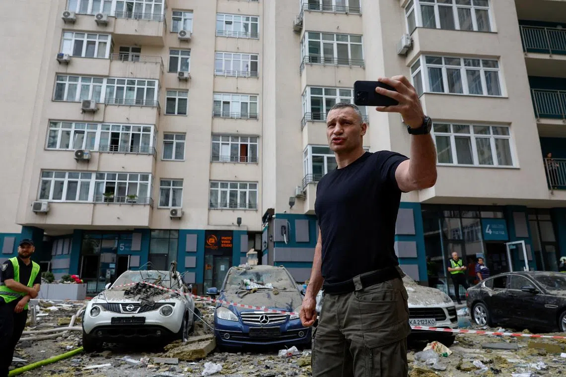 Kyiv Mayor Vitali Klitschko captures video at the site of a Russian missile strike in the city.