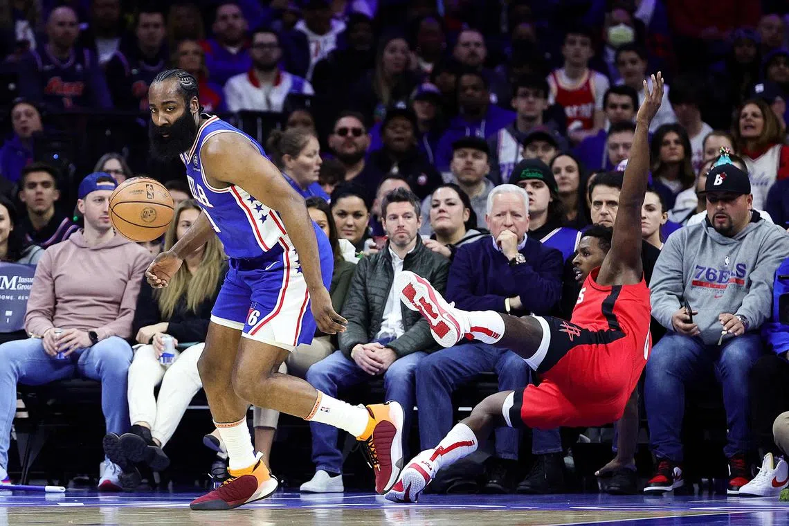James Harden (L) of the Philadelphia 76ers dribbles past Jae'Sean Tate (R) of the Houston Rockets during the first quarter of the match which saw the 76ers cruise past the rockets 123-104. 