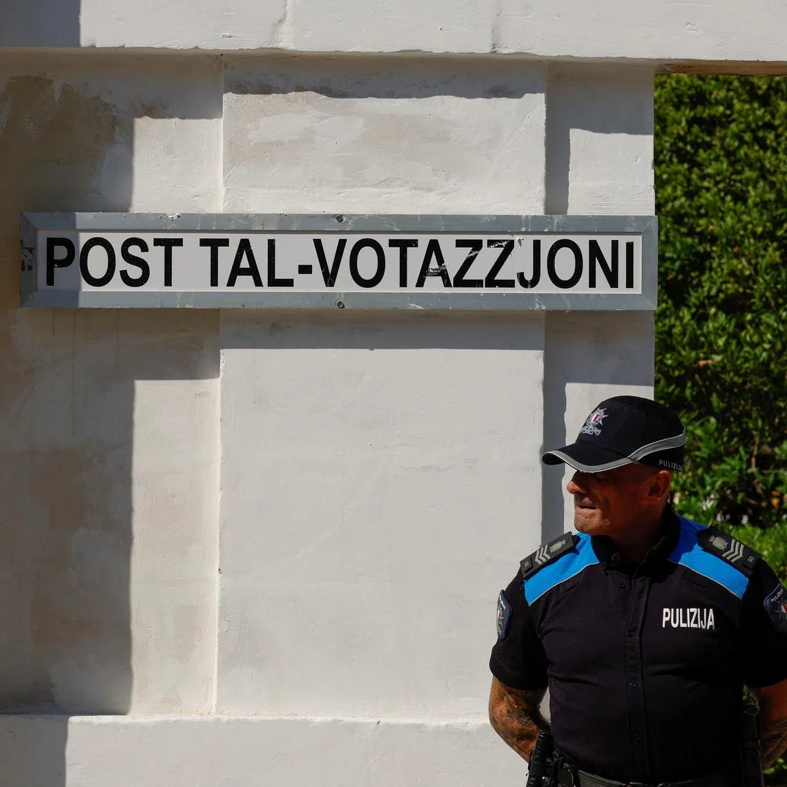 A police officer stands in front of a polling station during Malta's general election, in Zejtun, Malta, May 30, 2026.  REUTERS/Darrin Zammit Lupi