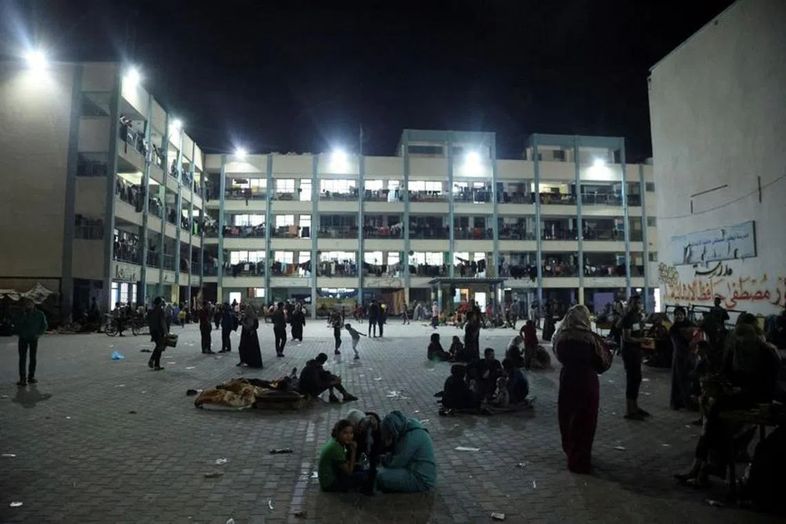 Palestinians, who fled their houses amid Israeli strikes, shelter at a United Nations-run school, after Israel's call for more than 1 million civilians in northern Gaza to move south, in Khan Younis in the southern Gaza Strip October 14, 2023. REUTERS/Ahmed Zakot