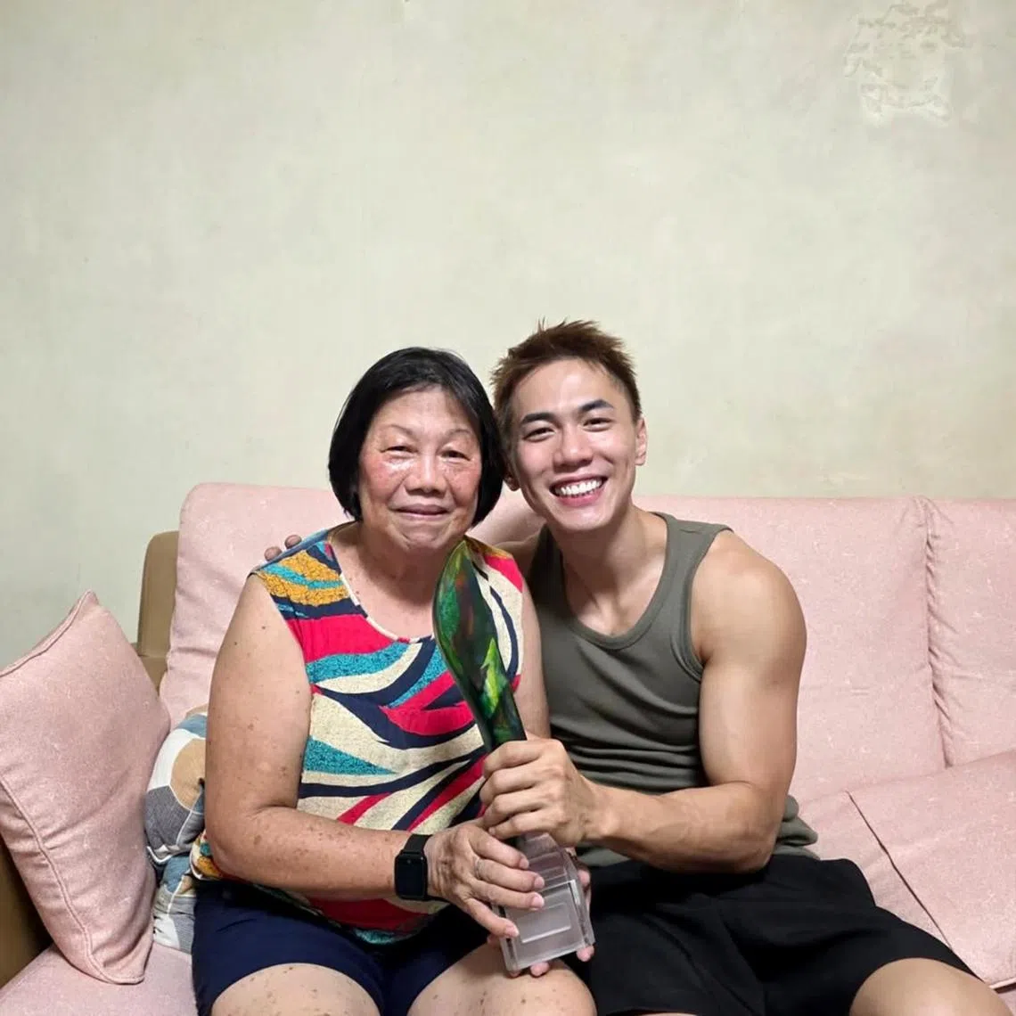 Nick Teo shared on social media on May 10 a photo of himself and his mother holding his Star Awards trophy. 