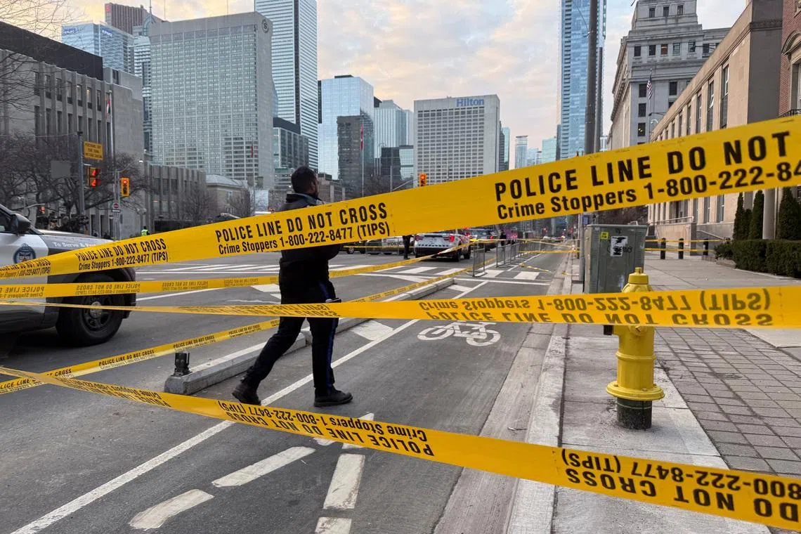 A member of law enforcement personnel working at the scene outside the US Consulate after shots were fired, in Toronto, Ontario, Canada, March 10.