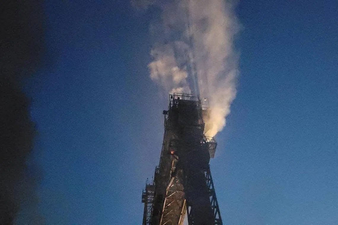A port grain loader burns after it was damaged during Russian missile and drone strikes, in Ukraine's Odesa region.