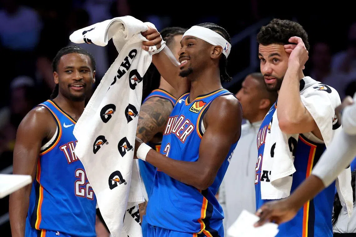 From left: Cason Wallace, Shai Gilgeous-Alexander and Ajay Mitchell of the Oklahoma City Thunder celebrating from the bench during the fourth quarter of the  the 131-108 win over the Los Angeles Lakers in the NBA Western Conference semi-finals on May 9, 2026.