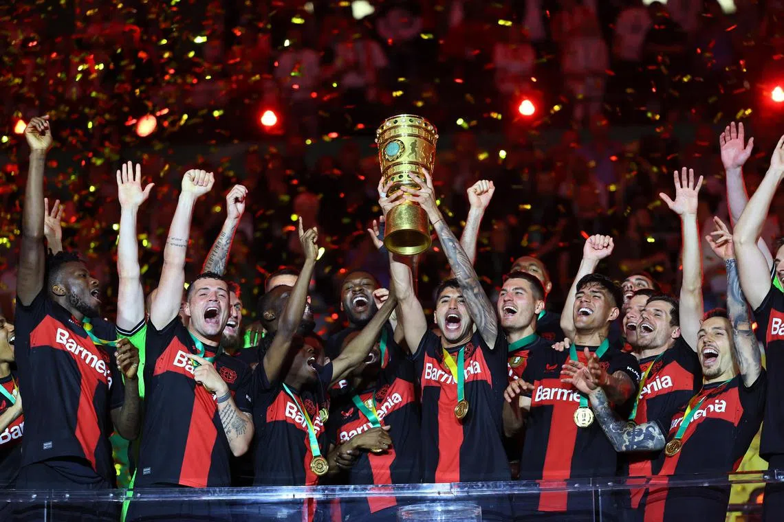 Bayer Leverkusen's Granit Xhaka celebrating with the trophy after his team won the German Cup, on May 25.