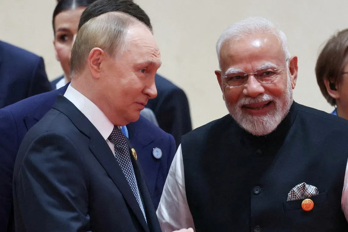 Russian President Vladimir Putin and Indian Prime Minister Narendra Modi speak during a meeting in Tianjin, China, on Sept 1.
