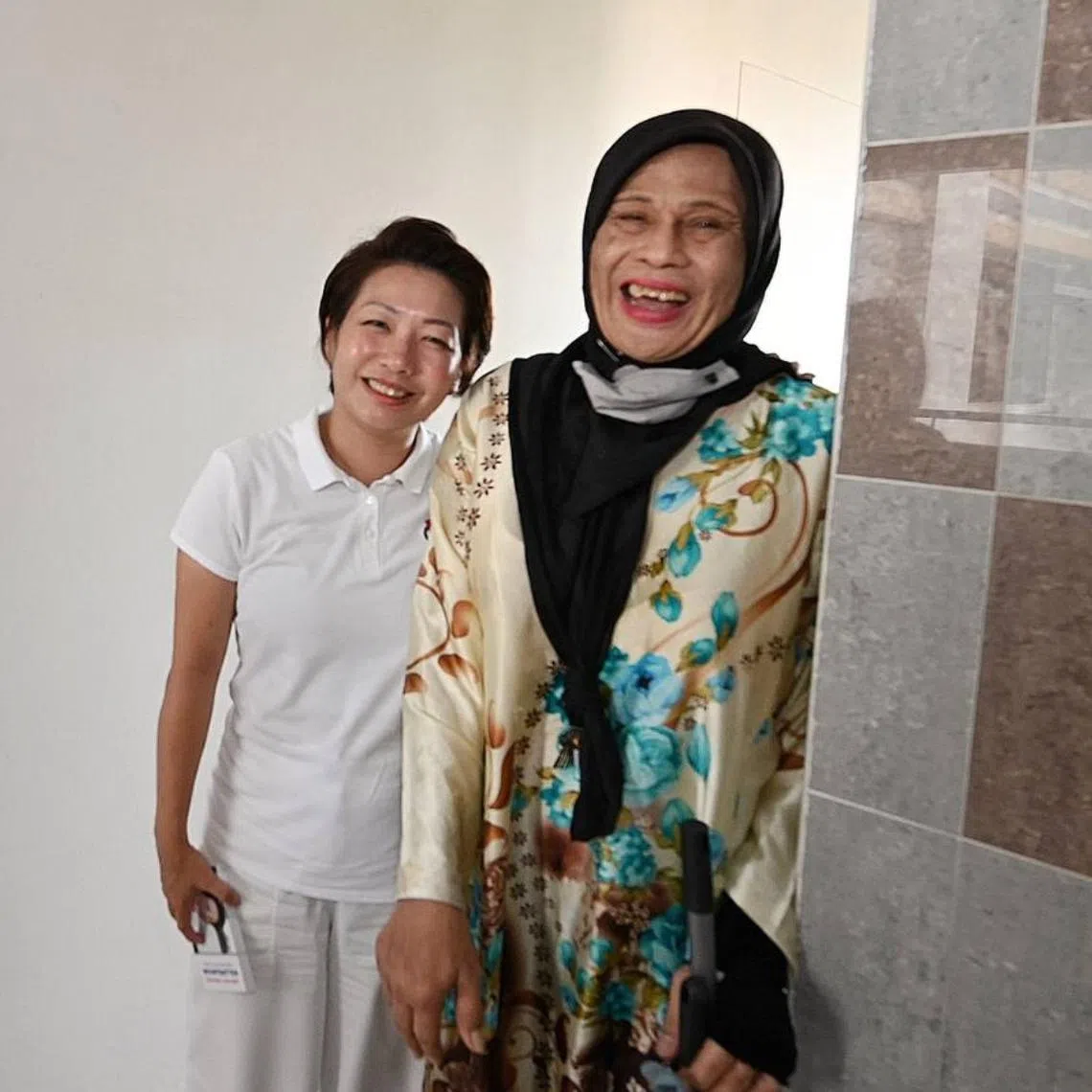 The PAP's Mountbatten candidate Gho Sze Kee with Pine Close estate cleaner Lana Abdul on April 29.