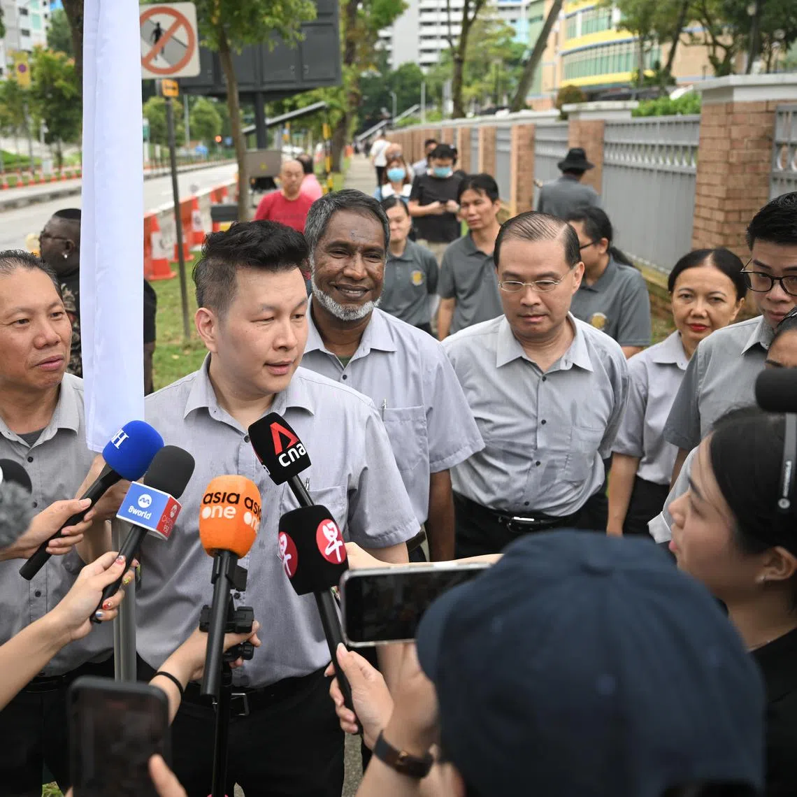 Singapore United Party secretary-general Andy Zhu speaking to the media outside Deyi Secondary School on April 23, 2025. With him are the party’s Ang Mo Kio GRC candidates (from his left) Ridhuan Chandran, Vincent Ng, Noraini Yunus and Nigel Ng. Mr Zhu and Ms Noraini contested in the GRC under the Reform Party banner in the 2020 General Election.