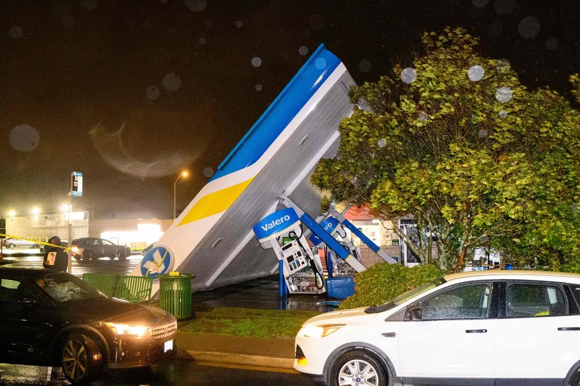 A damaged Valero gas station creaks in the wind during a massive "bomb cyclone" rainstorm in South San Francisco, California on Jan 4, 2023.