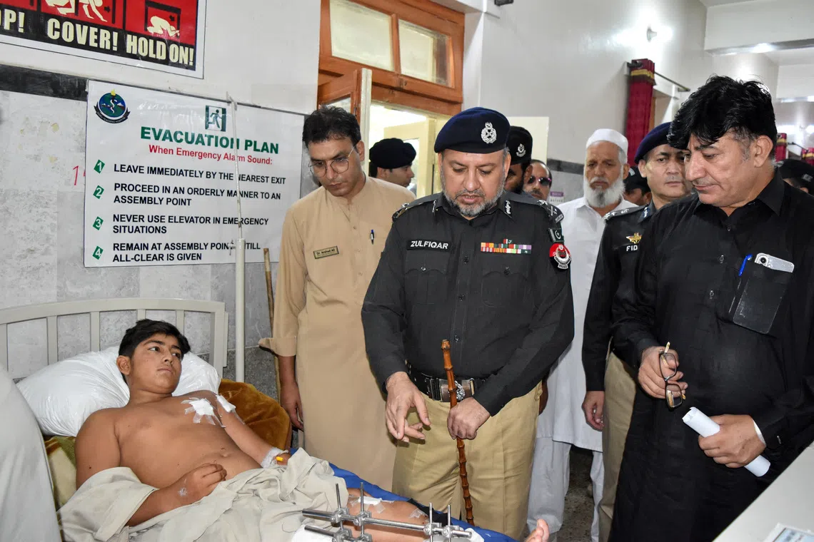 Inspector General of Police (IGP) Zulfiqar Hameed visits a boy who was among those injured in a suspected suicide bombing outside a police station, at a hospital in Swat district of Pakistan's Khyber Pakhtunkhwa province, Pakistan, August 3, 2026. REUTERS/Hazrat Ali Bacha
