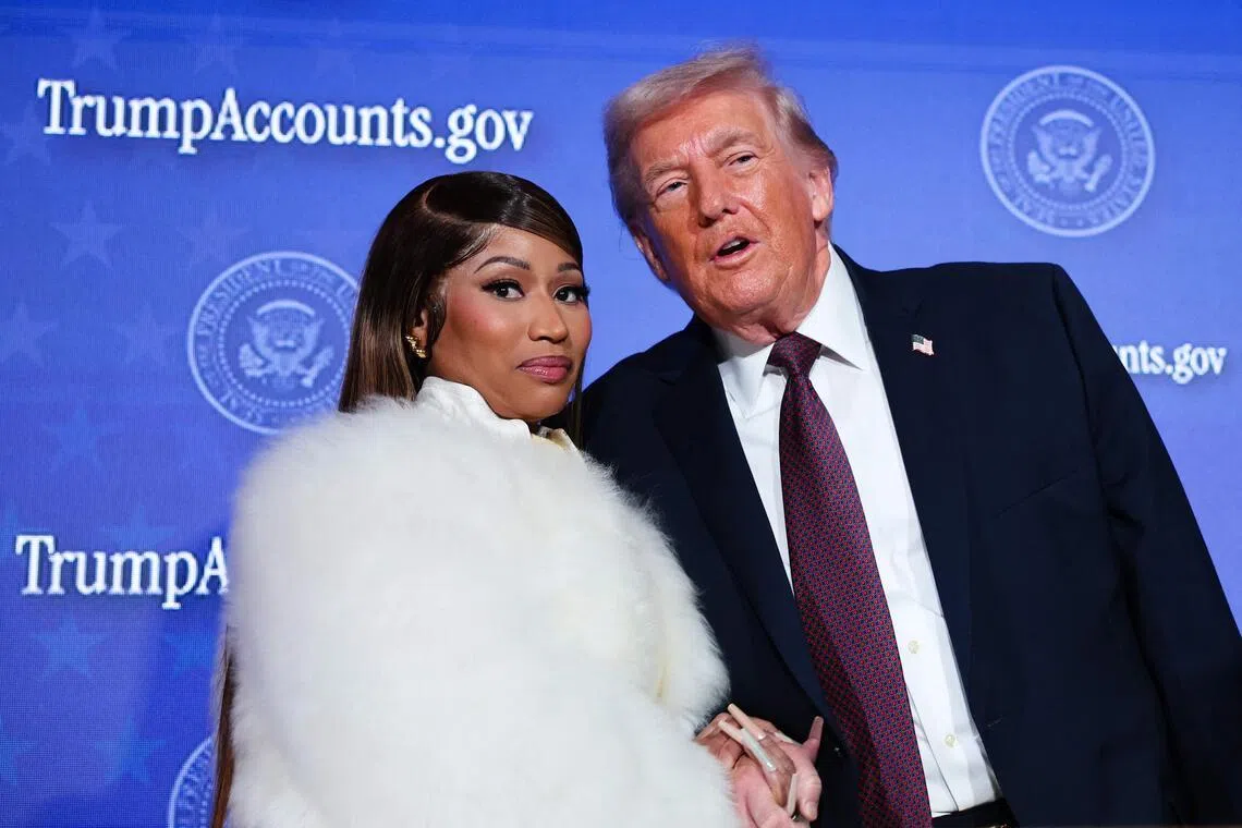 Musician Nicki Minaj (left) joins US President Donald Trump on stage as he delivers remarks during the Treasury Department's Trump Accounts Summit in Washington DC.  