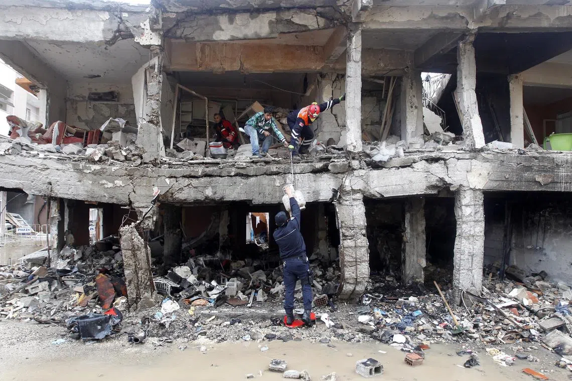 FILE PHOTO: Search and rescue officers work at a damaged building at the site of blast in the town of Reyhanli in Hatay province, near the Turkish-Syrian border, May 13, 2013. REUTERS/Umit Bektas/File Photo