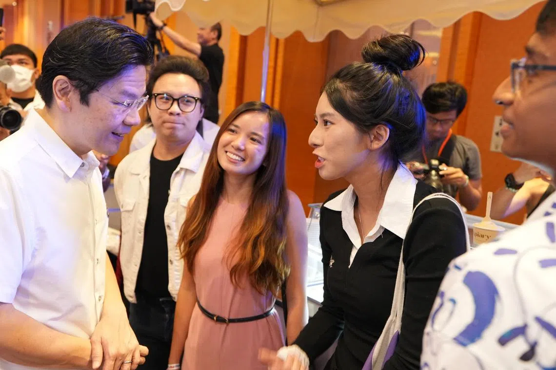 Prime Minister Lawrence Wong engaging with local content creators to share about the People's Action Party’s initiatives.