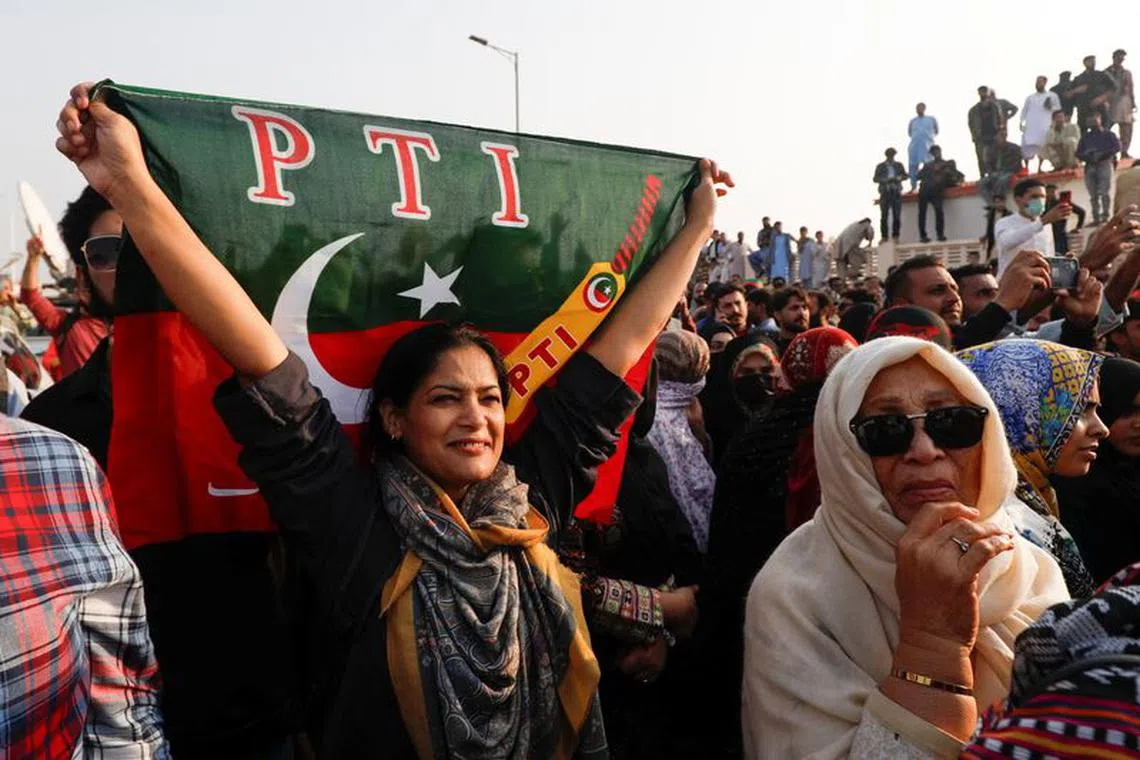A supporter of Pakistan Tehreek-e-Insaf (PTI) waves the party flag during a rally ahead of the general elections in Karachi, Pakistan January 14, 2024. REUTERS/Akhtar Soomro/ File Photo