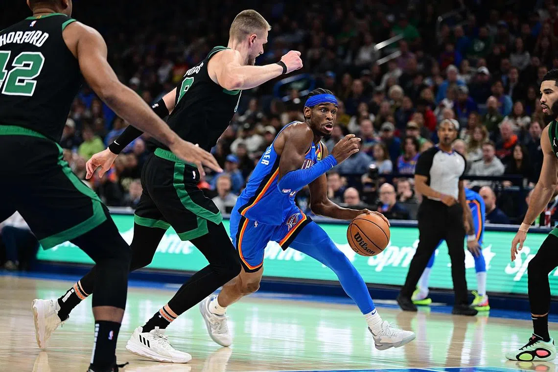 Shai Gilgeous-Alexander of the Oklahoma City Thunder attempts to drive past Kristaps Porzingis of the Boston Celtics during the second half at Paycom Centre.