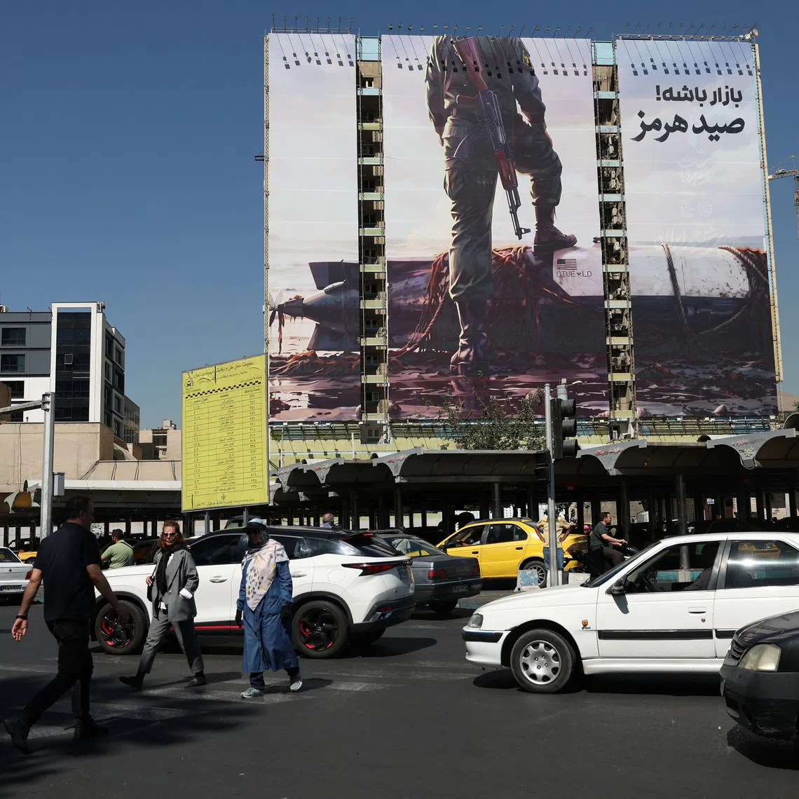 People walk past a billboard with a picture of an unmanned U.S. submersible, in Tehran, Iran, September 23, 2026. Majid Asgaripour/WANA (West Asia News Agency) via REUTERS
