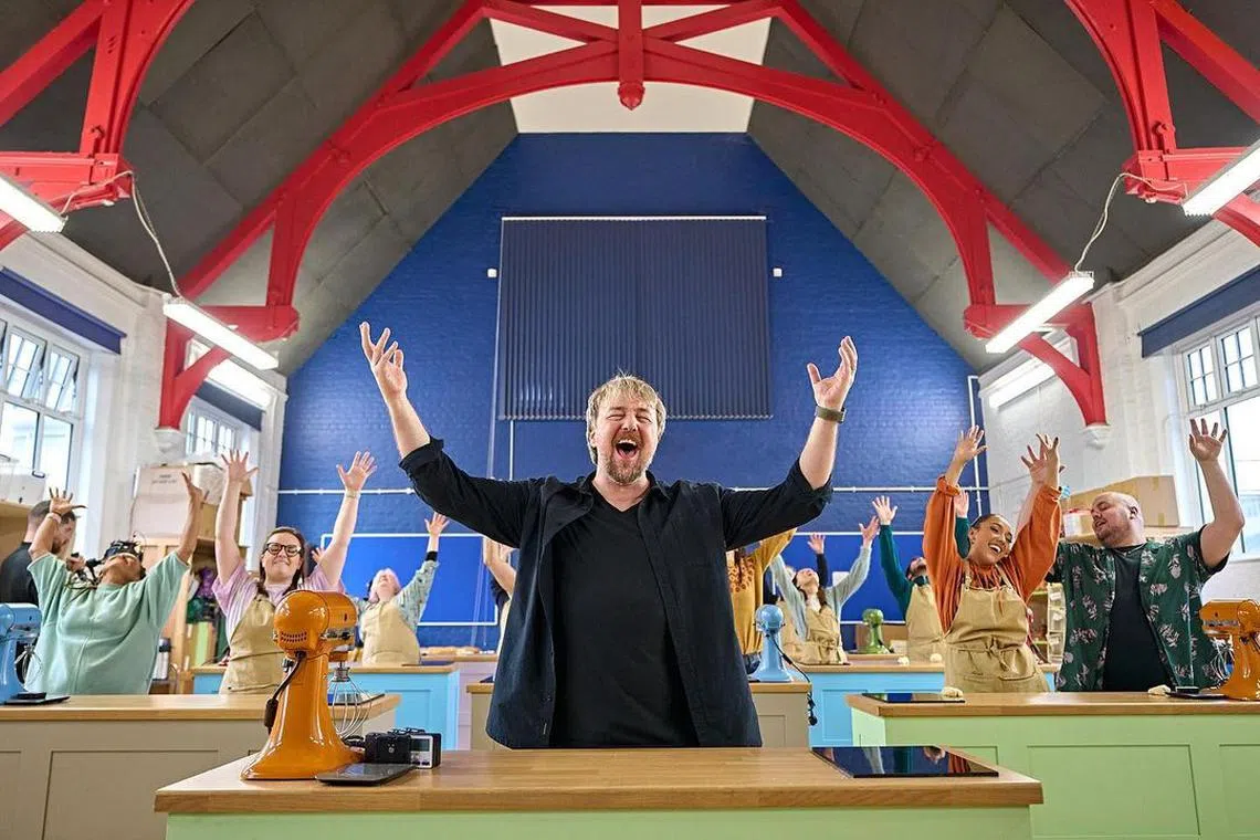 Actor John Owen-Jones (centre) plays a thinly veiled version of The Great British Bake Off judge Paul Holliday in the musical adaptation.