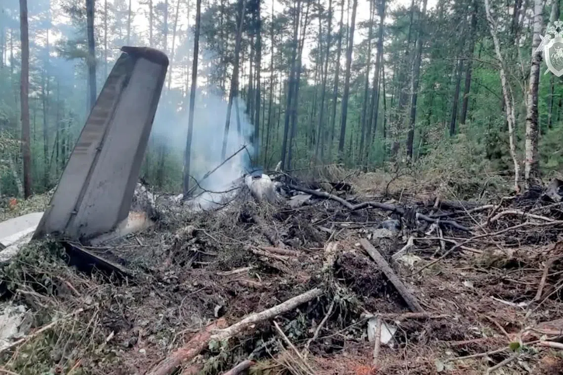 FILE PHOTO: A view shows the debris of an Angara Airlines An-24 passenger aircraft at the crash site near Tynda in the Amur Region, Russia July 24, 2025, in this still image taken from video. Russian Investigative Committee/Handout via REUTERS/File Photo