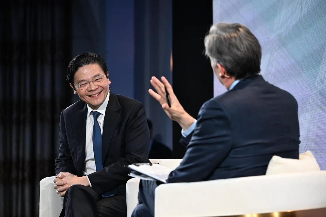 PM Lawrence Wong speaking at the Bloomberg New Economy Gala Dinner with moderator John Micklethwait on Nov 19.