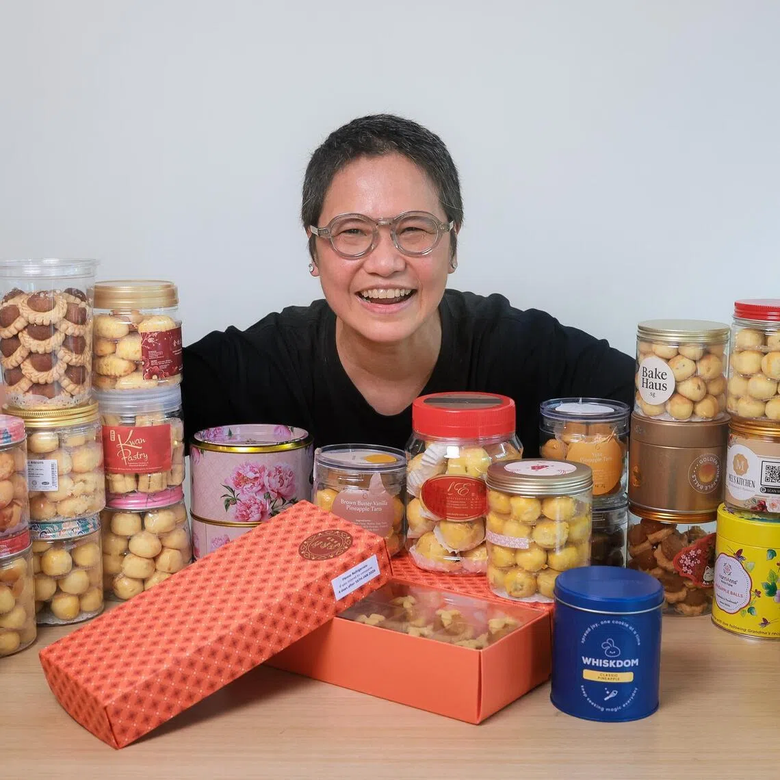 Private dining chef and content creator Shen Tan with 27 types of tarts she ordered to taste and review.