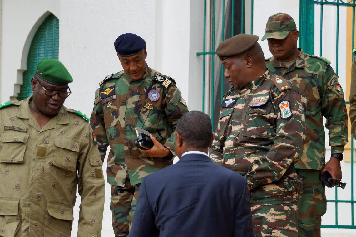 General Abdourahamane Tchiani (centre right), declared as Niger's new head of state, arrives to meet with ministers in the capital Niamey.