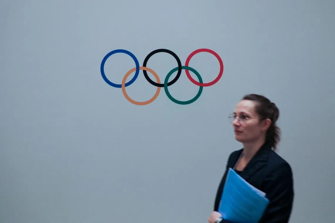 A woman walks past a logo of Olympics during a meeting of International Olympic Committee (IOC), ahead of the 141st IOC Session, in Mumbai, India, October 13, 2023. REUTERS/ Niharika Kulkarni