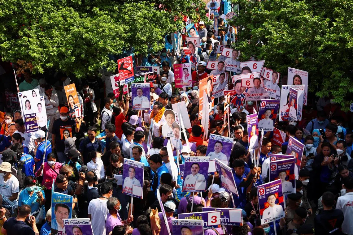 Supporters of the constituency candidates gather outside the registration centre as the candidates register for the upcoming election, in Bangkok, Thailand, April 3, 2023. REUTERS/Athit Perawongmetha