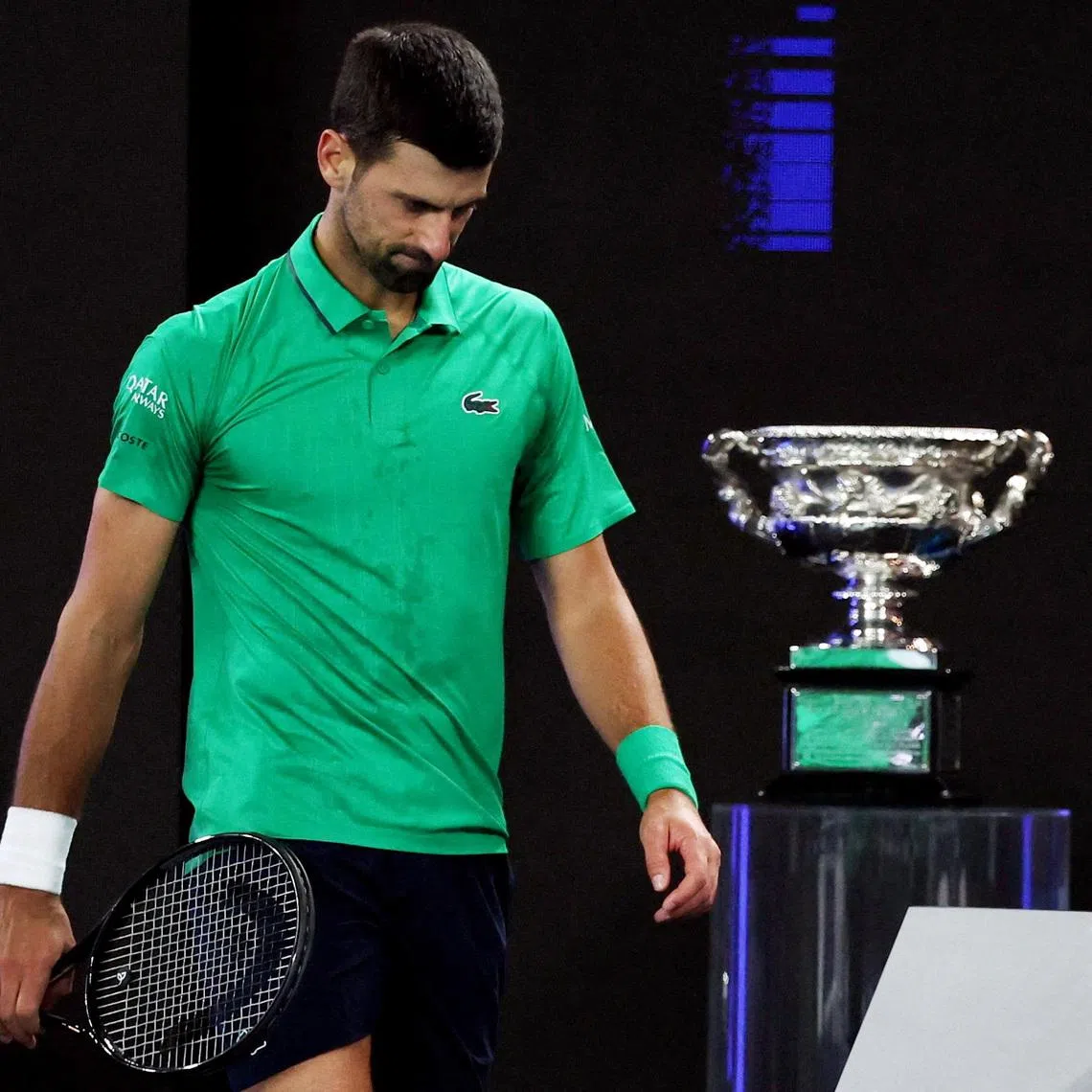 Tennis - Australian Open - Melbourne Park, Melbourne, Australia - February 1, 2026 Serbia's Novak Djokovic during the men's singles final against Spain's Carlos Alcaraz as the trophy is on display REUTERS/Edgar Su