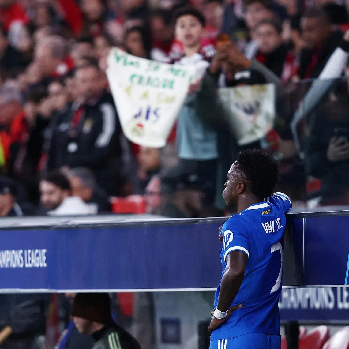 Soccer Football - UEFA Champions League - Play Off - First Leg - Benfica v Real Madrid - Estadio da Luz, Lisbon, Portugal - February 17, 2026 Real Madrid's Vinicius Junior looks on from the side of the pitch as the match was stopped due to racist chants REUTERS/Rodrigo Antunes