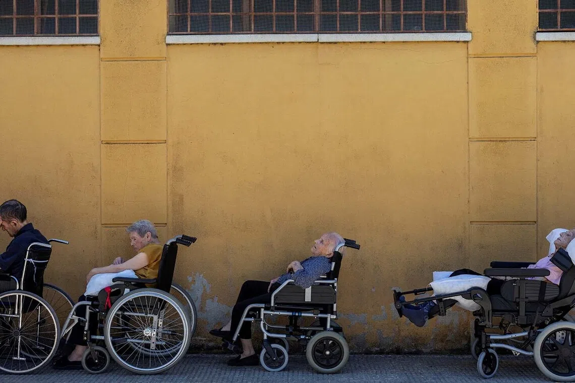Elderly residents who spent the night in a sports hall converted into a shelter after being evacuated due to the wildfire threat wait to be transferred back to their permanent residence, Conchita Regojo Care Home, after the danger had passed in Fermoselle, Spain, July 30, 2026. REUTERS/Umit Bektas TPX IMAGES OF THE DAY