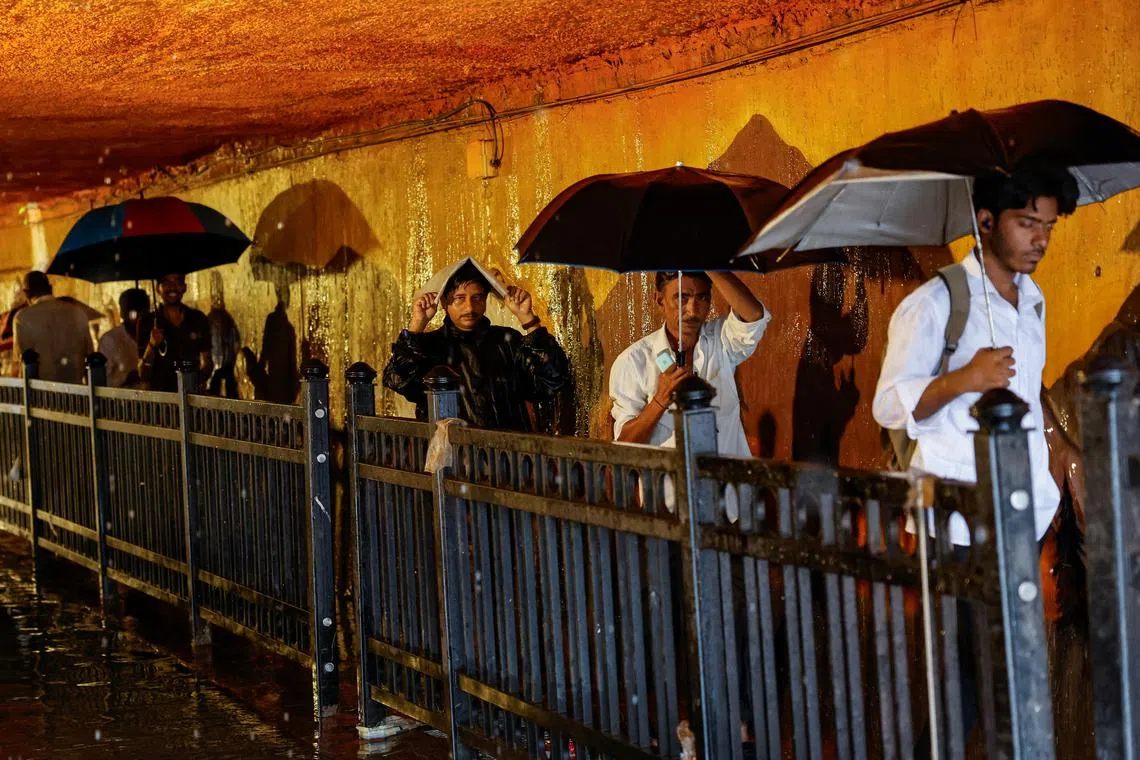 People walk in a waterlogged subway after heavy rains in Mumbai, India, July 8, 2024. REUTERS/Francis Mascarenhas