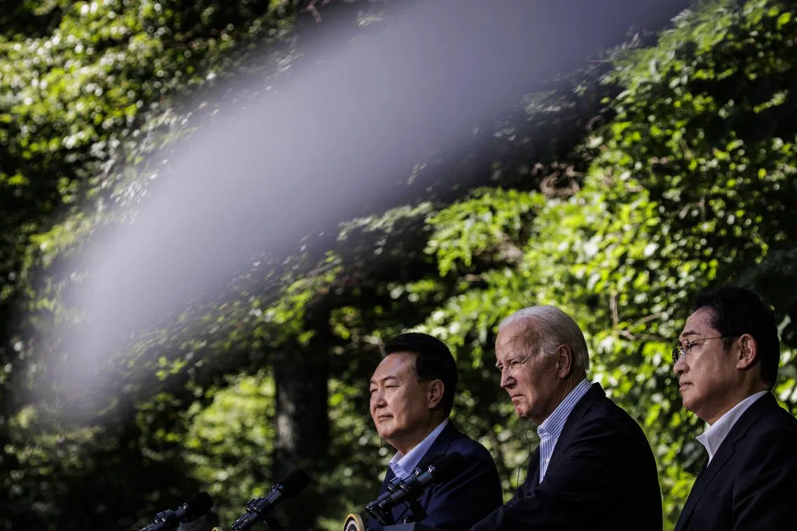 (From left) South Korean President Yoon Suk-yeol, US President Joe Biden and Japanese Prime Minister Kishida Fumio at Camp David on Aug 18.