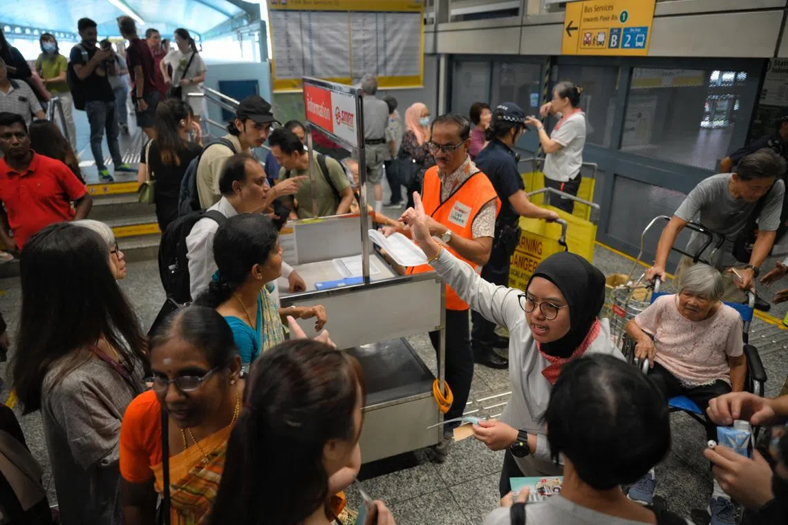 SMRT employees directing commuters away from Clementi MRT station after a train fault between Boon Lay and Queenstown on Sept 25, 2024.